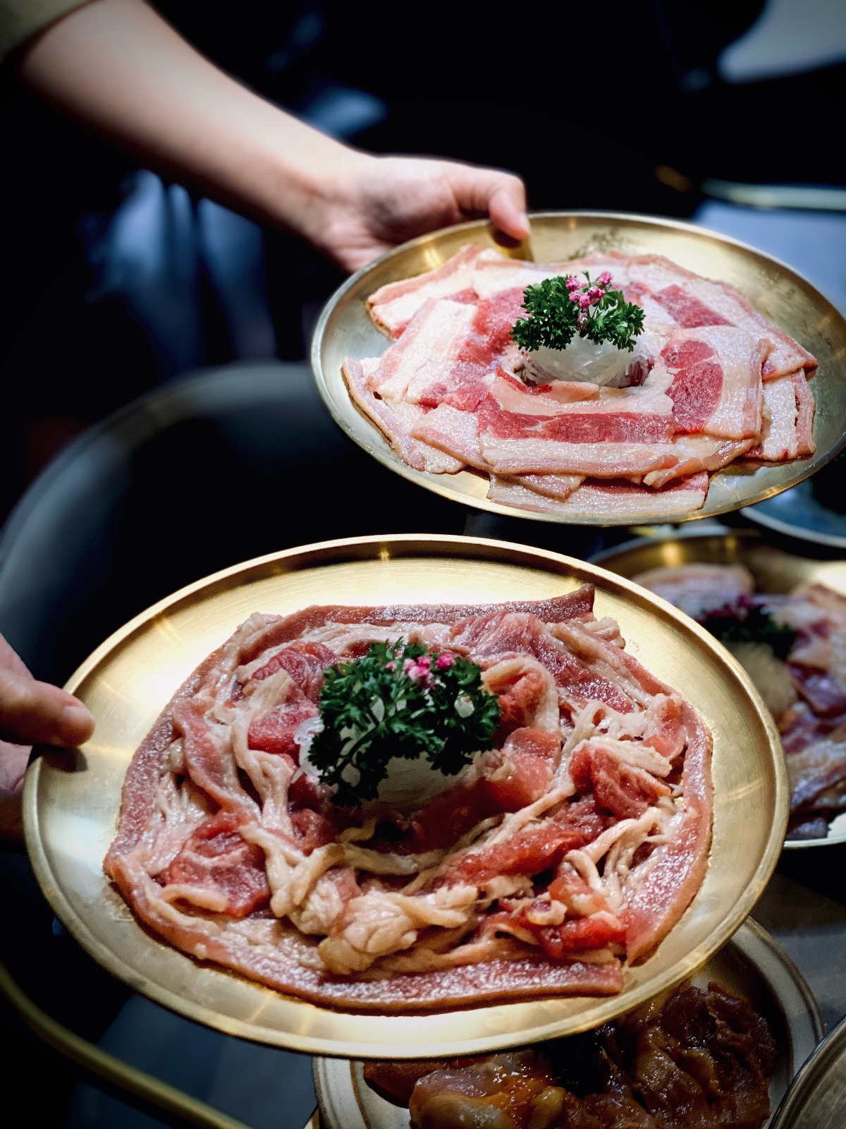 Premium pork belly arranged on traditional brass trays